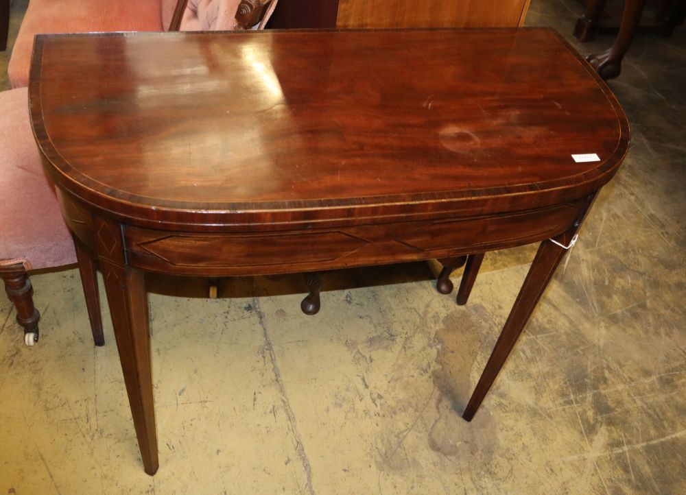 A George III banded mahogany D shaped folding card table, W.87cm, D.44cm, H.72cm